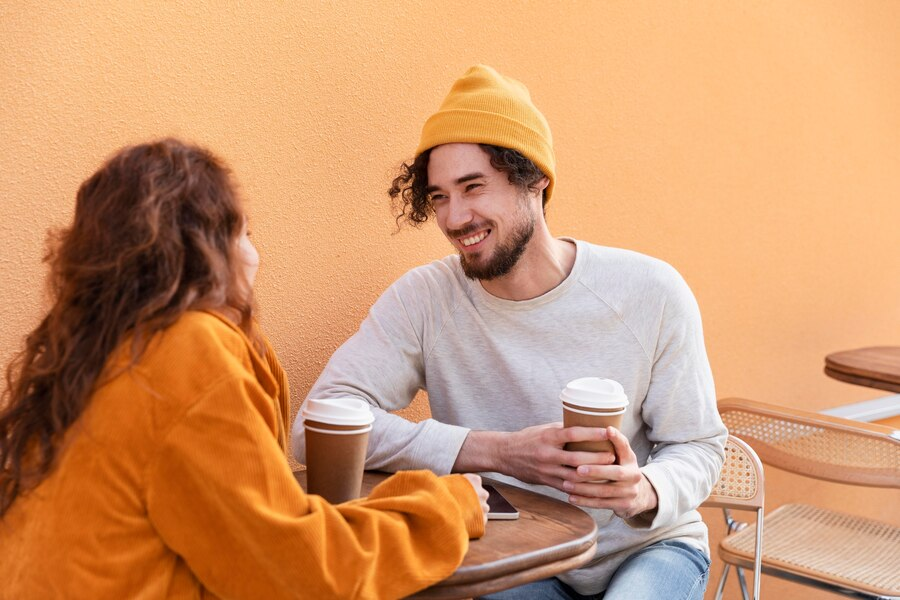 Man and woman chatting over coffee.